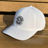 White cap with a logo on a wooden surface